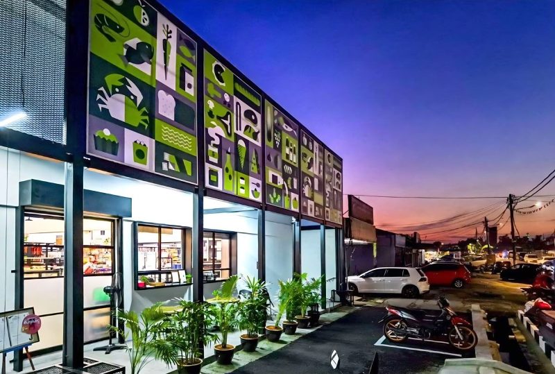 Upgraded mini market facade at dusk with graphic panels
