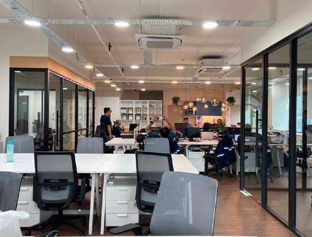 Open-plan workspace with glass-walled rooms