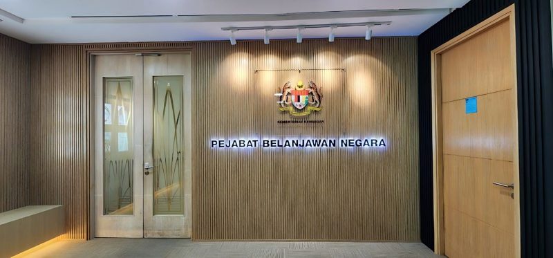 Lobby with timber slat walls and Pejabat Belanjawan Negara signage