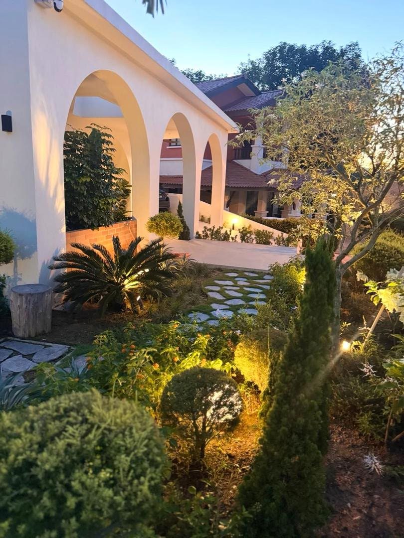 Garden lighting along the arched walkway at dusk