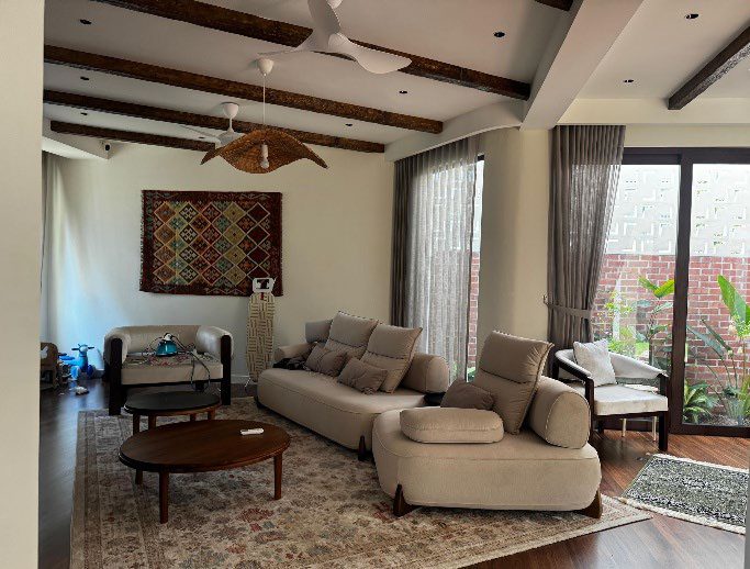 Living room with sofas and timber ceiling beams
