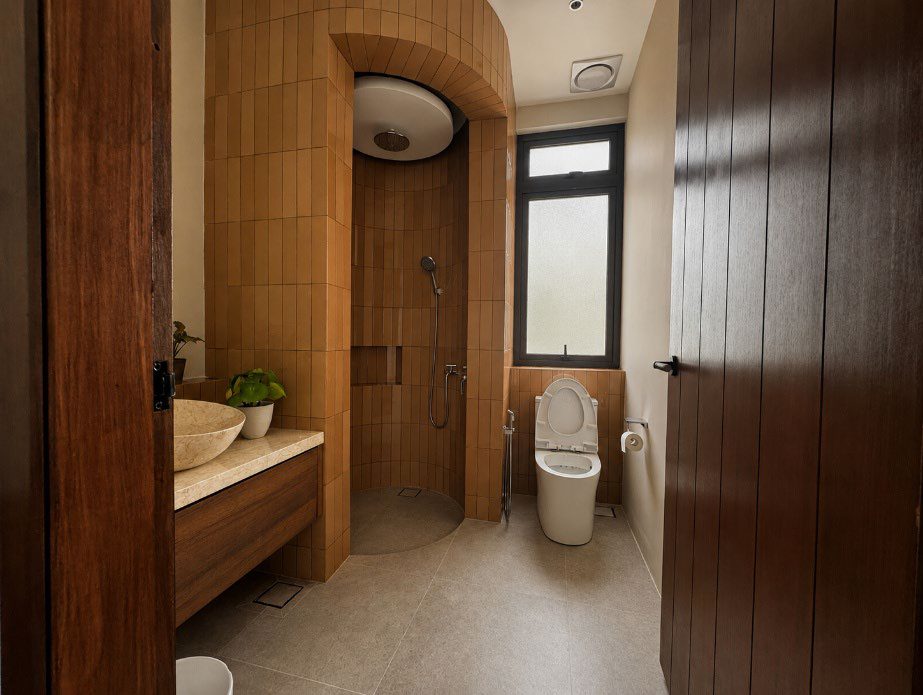 Bathroom with timber-toned tiles and arched shower