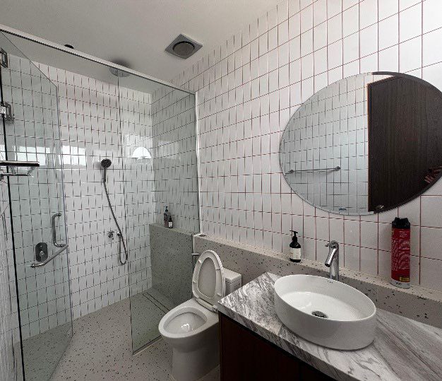 White tiled bathroom with glass shower
