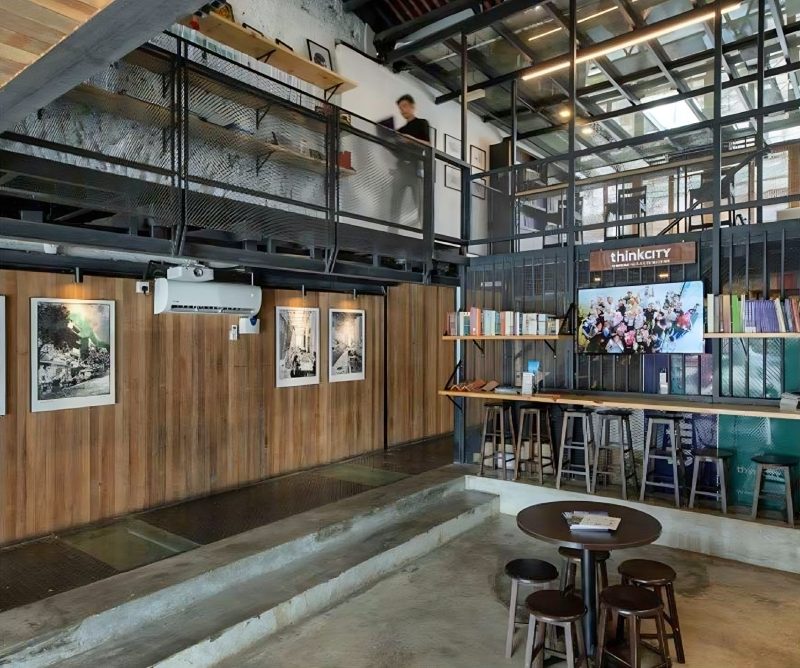 Think City office interior with steel mezzanine and bookshelves
